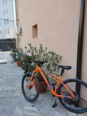an orange bike parked next to a building at House Leyla in Bihać