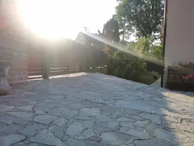 a stone patio with the sun shining on it at House Leyla in Bihać