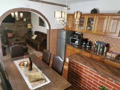 a kitchen and living room with a table and a couch at House Leyla in Bihać