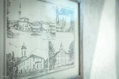 a framed drawing of a building on a wall at Becar Pyramid Rooms in Visoko
