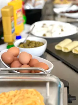a counter with eggs and other food on a table at Becar Pyramid Rooms in Visoko