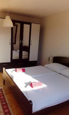 a bedroom with a large bed with two pillows on it at Honey Apartments in Visoko
