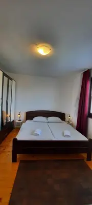 a bedroom with a bed with two towels on it at Honey Apartments in Visoko
