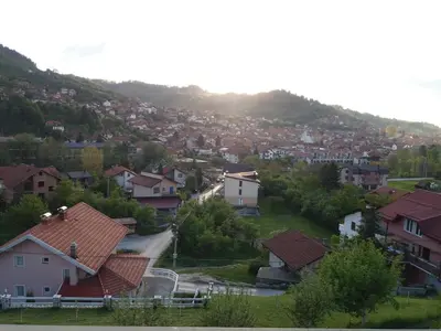 a view of a village with houses on a hill at Honey Apartments in Visoko