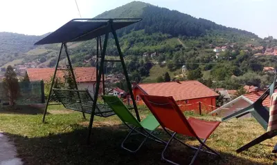 a group of chairs sitting on top of a hill at Honey Apartments in Visoko