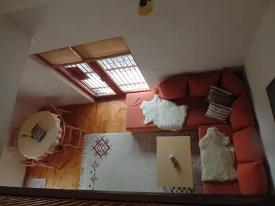 a living room with a red couch and a window at Holiday Home Alibegović in Visoko