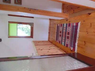 an empty room with a window and wooden walls at Holiday Home Alibegović in Visoko