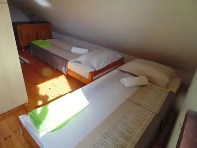a bedroom with two beds and a book on the floor at Holiday Home Alibegović in Visoko