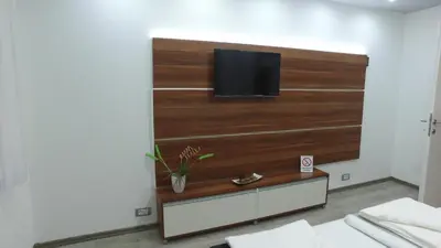 a room with a flat screen tv on a wall at Apartman 