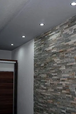 a room with a stone wall and a brick wall at Apartman 