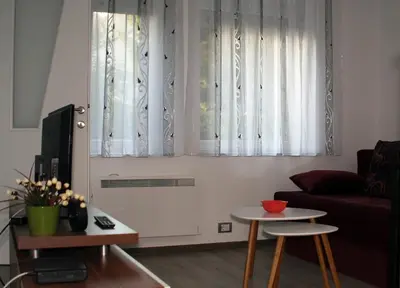 a living room with a couch and a table at Apartman 