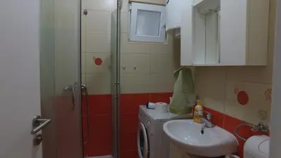 a bathroom with a shower and a sink at Apartman 