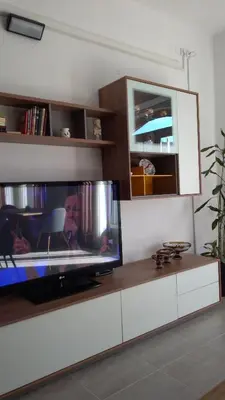 a flat screen tv sitting on a counter in a living room at Guesthouse Jelic in Teslić