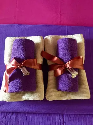 two purple towels with bows on a purple table at Guesthouse Jelic in Teslić