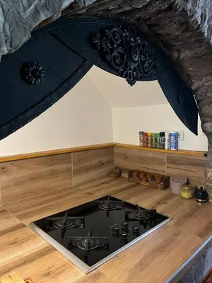 a stove top in a kitchen with a counter top at Apartment Green Lagoon in Bihać