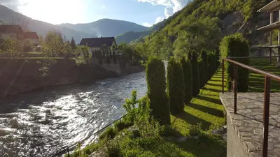 a river with trees on the side of a mountain at holiday home RIVER HOUSE in Jajce