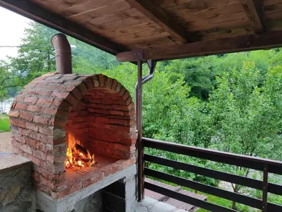 an outdoor brick oven on a deck at holiday home RIVER HOUSE in Jajce