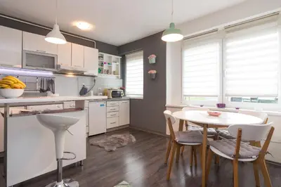 a kitchen with a table and chairs in a room at Apartment Amra in Visoko