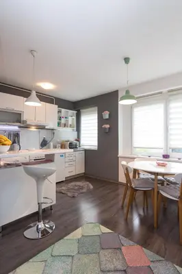 a kitchen and dining room with a table and chairs at Apartment Amra in Visoko