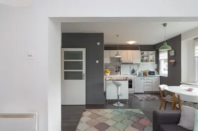 a kitchen and living room with a couch and a table at Apartment Amra in Visoko