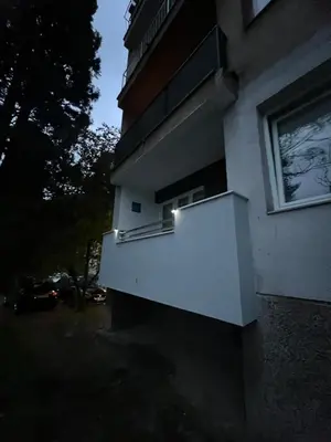 a building with a balcony with a light on it at Apartment Amra in Visoko