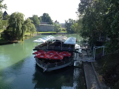 a group of boats are docked on a river at Apartment Mirjana in Banja Luka
