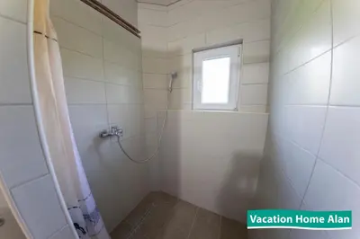 a bathroom with a shower and a window at Vacation home Alan in Kulen Vakuf
