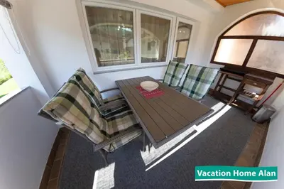 a living room with a table and two chairs at Vacation home Alan in Kulen Vakuf