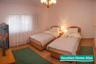 a room with two beds and a tv in it at Vacation home Alan in Kulen Vakuf