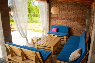 a patio with chairs and a bench and a table at Holiday Home Faruk in Račić