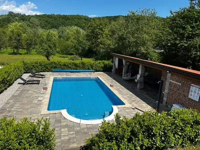 a swimming pool on a patio next to a house at Holiday Home Faruk in Račić
