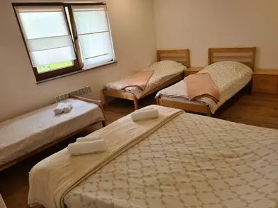 a room with three beds and a window at Holiday Home Faruk in Račić