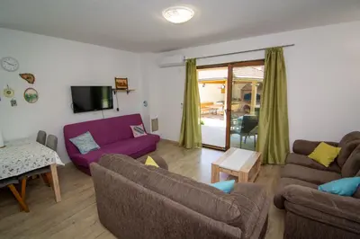 a living room with two couches and a tv at Holiday Home Faruk in Račić