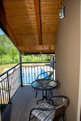 a patio with a table and chairs on a balcony at Holiday Home Faruk in Račić