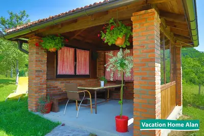 a patio with a table in a brick house at Vacation home Alan 2 in Kulen Vakuf