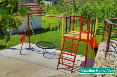 a playground with a swing and a ladder at Vacation home Alan 2 in Kulen Vakuf