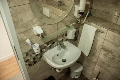 a bathroom with a sink and a mirror at Apartments Bašić in Visoko