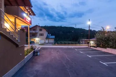a parking lot in front of a hotel at Apartments Bašić in Visoko