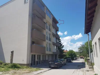 a building with cars parked in front of it at Apartman Banja - Tuzla in Tuzla