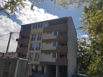 a tall apartment building in front of a blue sky at Apartman Banja - Tuzla in Tuzla