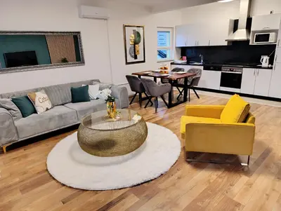 a living room with a couch and a table at Apartmani Jasmina 2 in Bihać