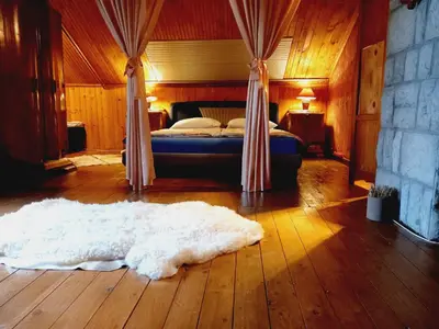 a bedroom with a bed and a white rug on the floor at Holiday Home Nature Neno in Visoko