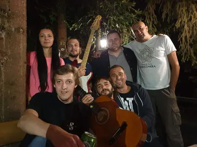 a group of men posing for a picture with a guitar at Holiday Home Nature Neno in Visoko