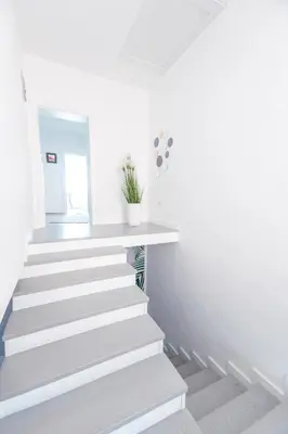 a staircase in a white room with white walls at Holiday Home Ajna in Bihać