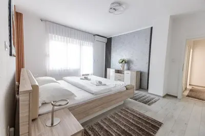 a bedroom with a large bed and a window at Holiday Home Ajna in Bihać