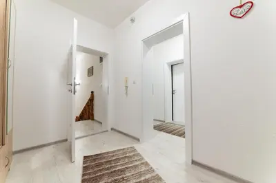 a hallway with white walls and an open door at Holiday Home Ajna in Bihać