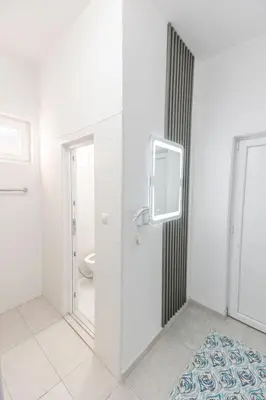 a bathroom with a towel dispenser on the wall at Holiday Home Ajna in Bihać