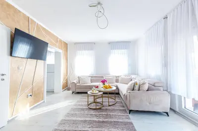 a living room with a couch and a table at Holiday Home Ajna in Bihać