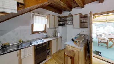 a kitchen with a sink and a stove top oven at Holiday home 