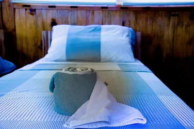 a blue and white bed with a towel on it at Holiday home 